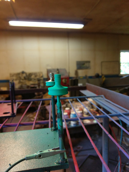 Metal Spinning Top in the process of being powdercoated