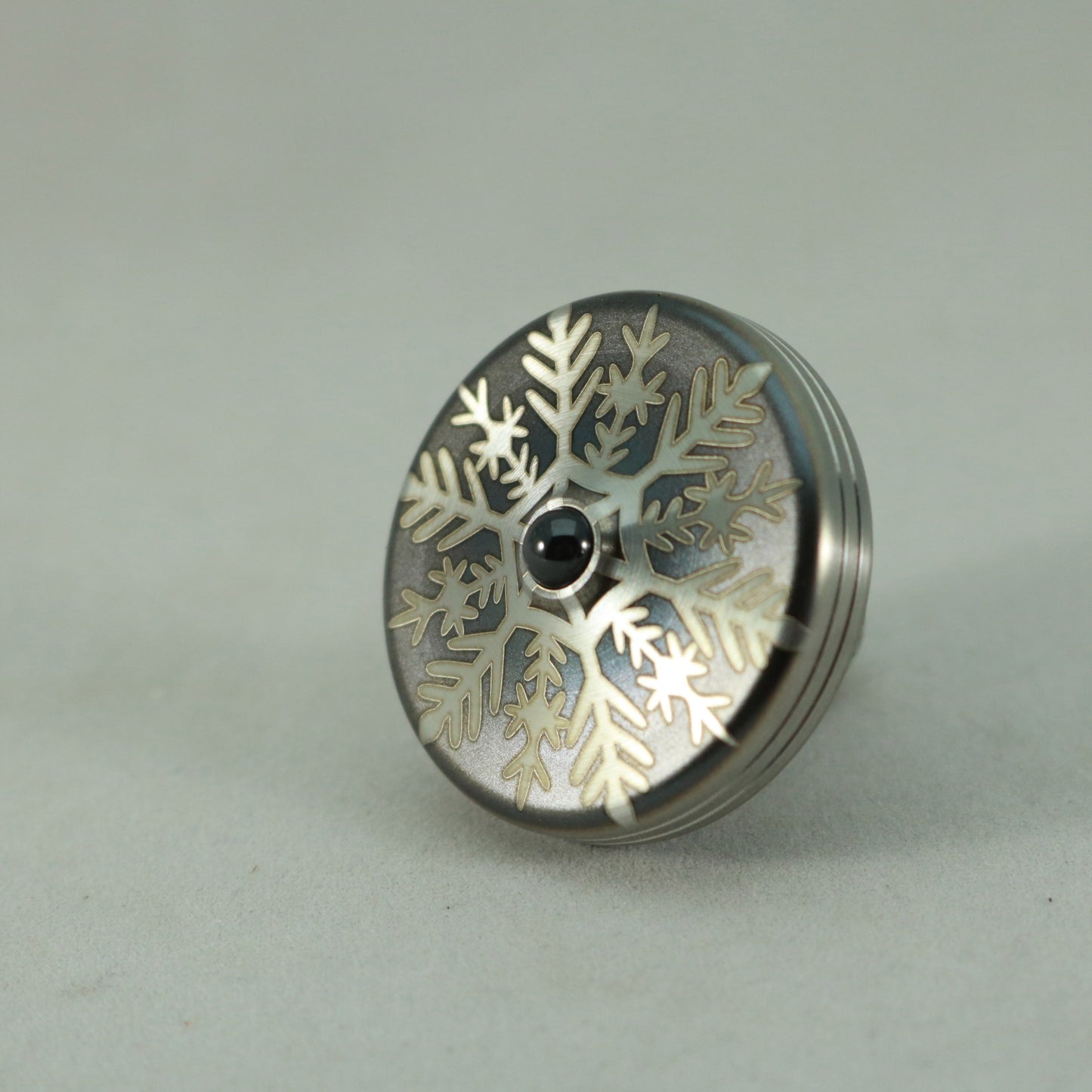 S2- Laser Etched Inverted Snowflake on a Stainless Steel Spinning Top