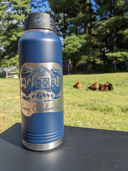 32 oz navy Polar Camel water bottle photographed outdoors with laser engraved Crazy Chicken Lady barnyard design, chickens visible in background