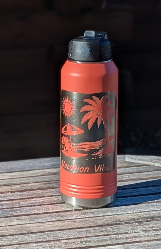 Coral water bottle with tropical design and 'Vacation Vibes' text on a wooden surface.