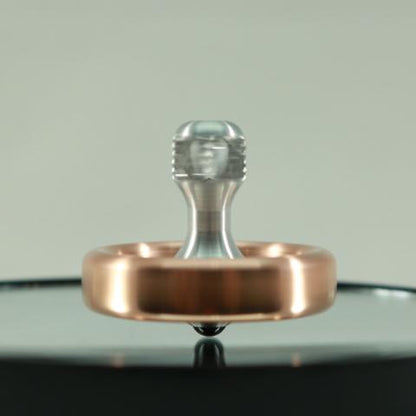 Kemner Design's Dynamo spinning top in copper and aluminum