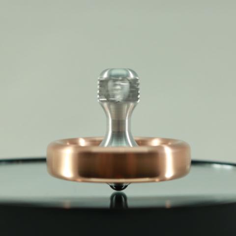 Kemner Design's Dynamo spinning top in copper and aluminum