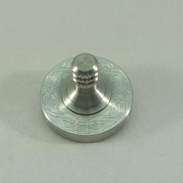 Solid stainless steel spinning top with engraved ring by Kemner Design