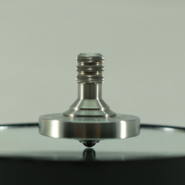 Two step spinning top in stainless steel with an engraved ring by Kemner Design