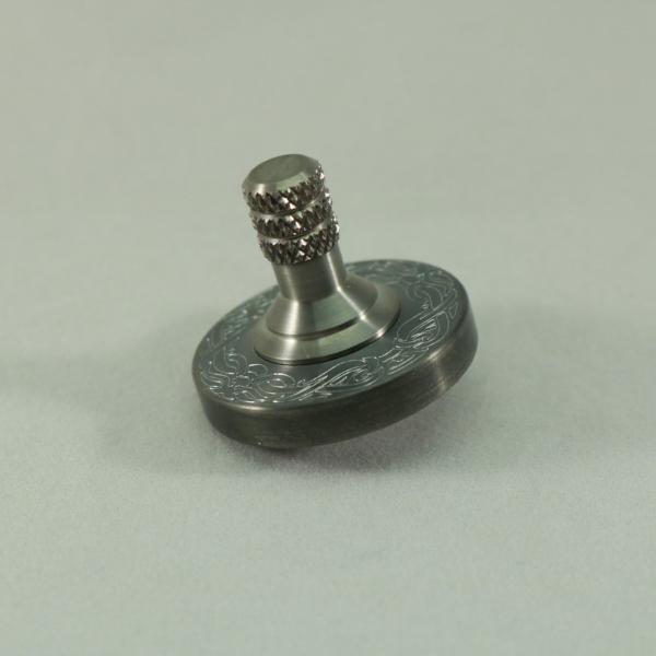 Two Step Spinning Top in Engraved Gunmetal Stainless Steel and Brushed Titanium by Kemner Design