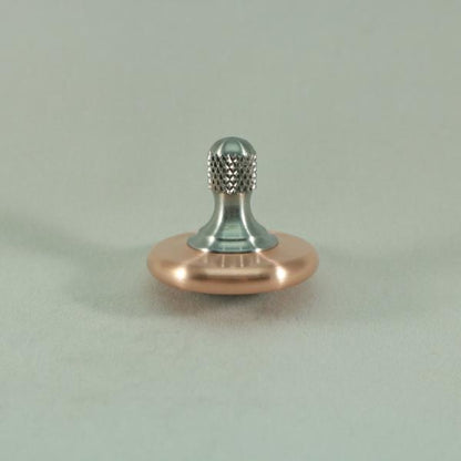 Kemner Design's M3 metal spin top shown here in brushed copper and stainless steel