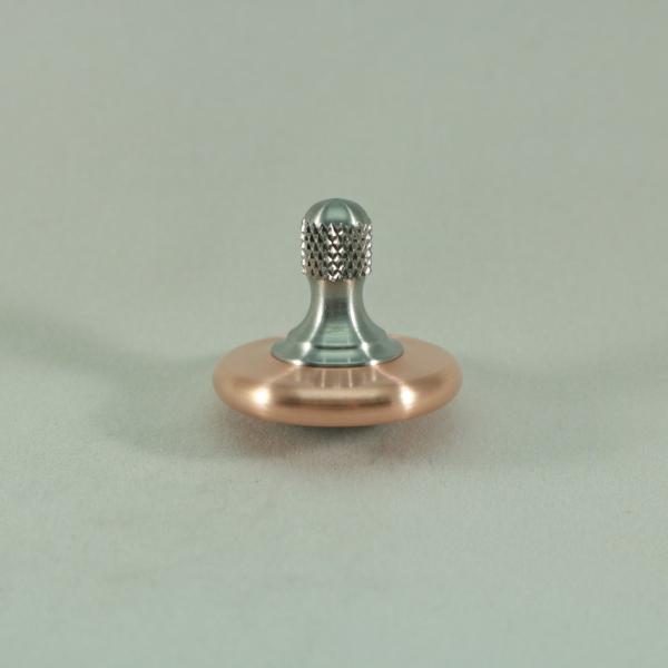 Kemner Design's M3 metal spin top shown here in brushed copper and stainless steel