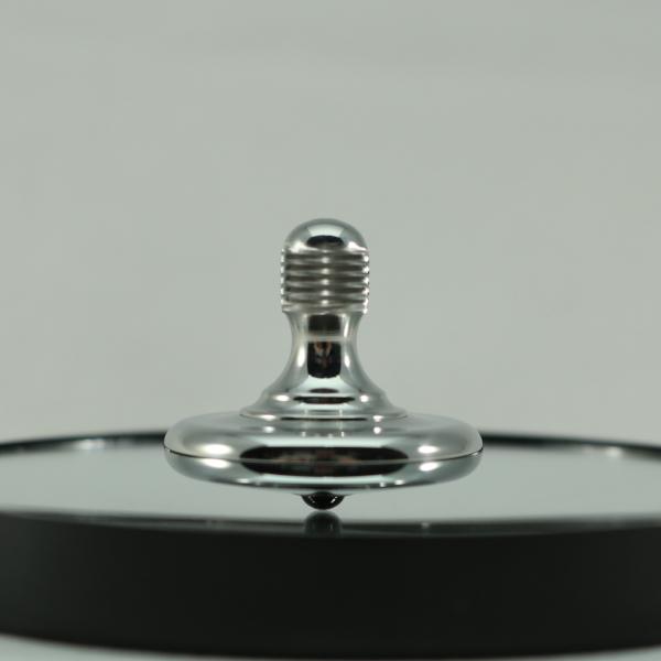 M3 precision metal spinning top in polished stainless steel by Kemner Design