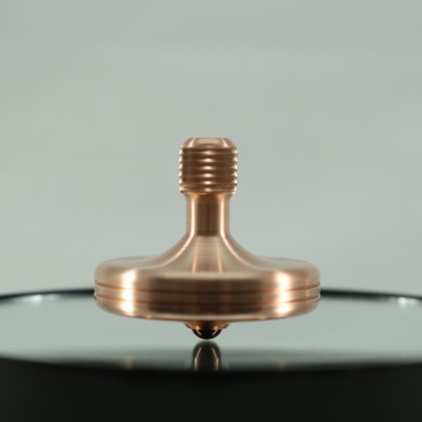 Kemner Design S2 precision spinning top seen here in brushed copper