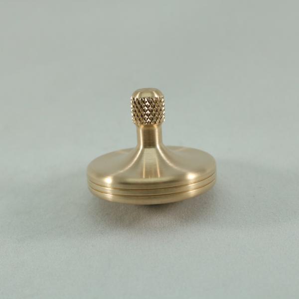 Brushed phosphor bronze S2 metal spin top by Kemner Design