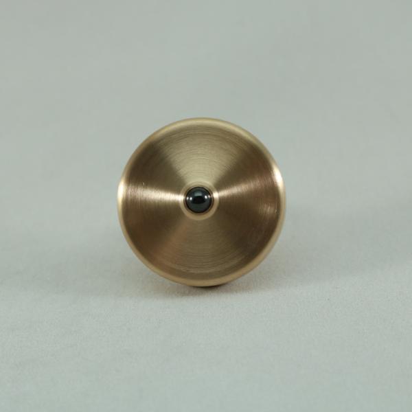 Bottom view showing the ceramic bearing of the S2 precision spinning top by Kemner Design seen here in brushed phosphor bronze