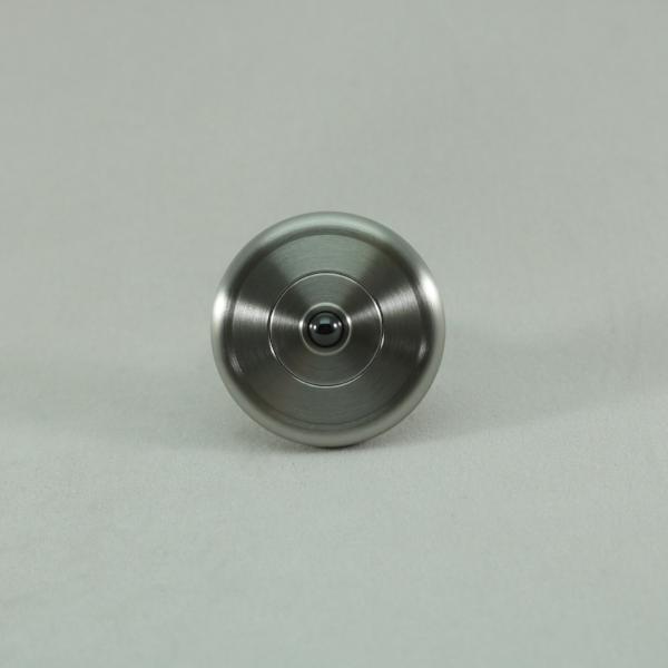 M3 precision machined metal spinning top shown in brushed stainless steel
