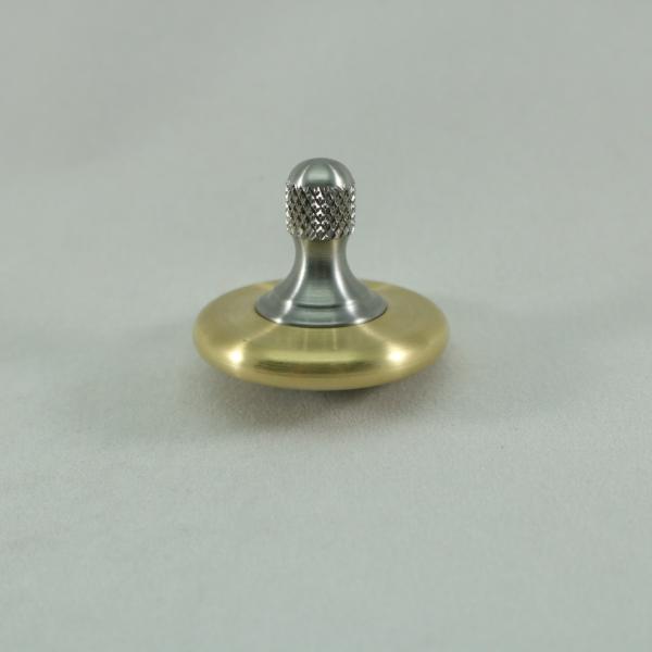 Knurled stainless steel stem and brushed brass ring on the M3 precision metal spinning top