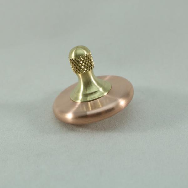M3 precision metal spinning top in copper and brass with a knurled stem