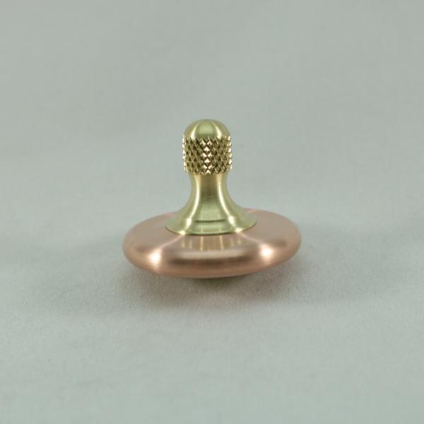 Kemner Design's M3 spinning top shown here in brushed copper and brass