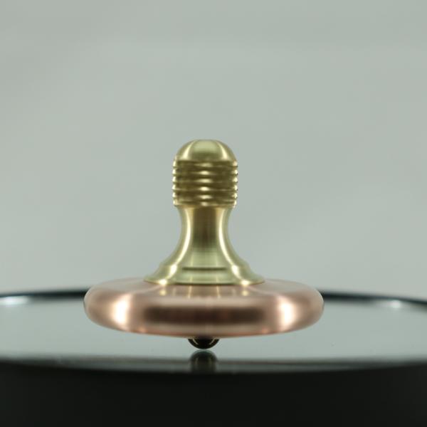 M3 precision metal spinning top shown here in copper and brass