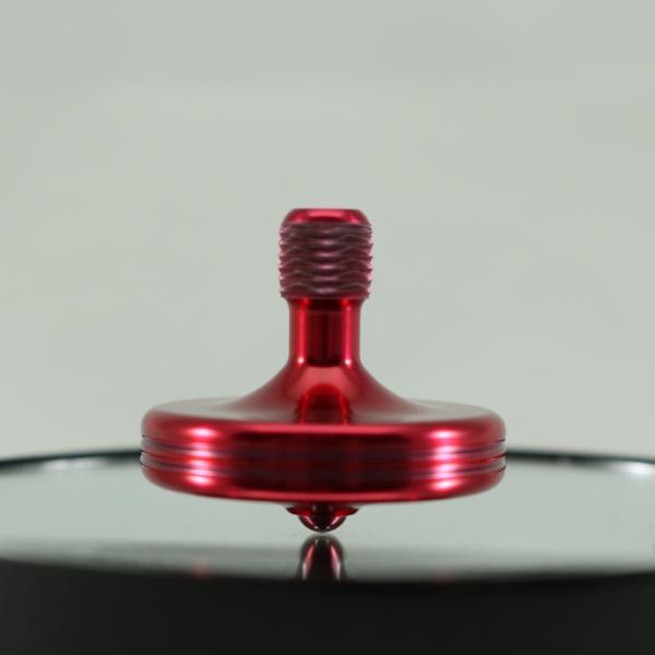 The S2 metal spinning top by Kemner Design in candy red aluminum