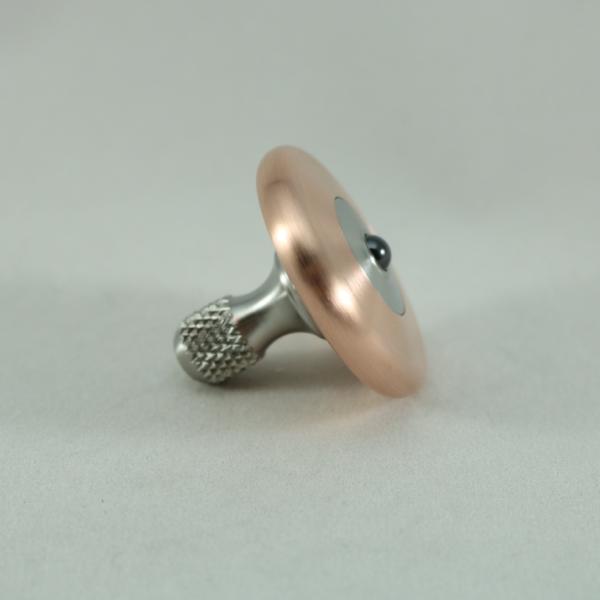 Side view of the M3 spinning top with a brushed copper ring and stainless steel stem