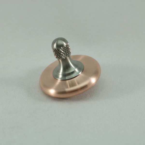 Copper and titanium M3 spinning top with a brushed finish