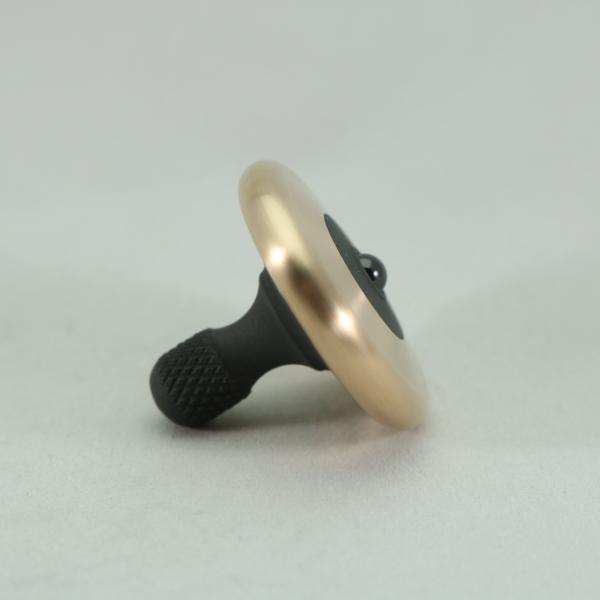 Side view of the M3 brushed bronze and blacked out stainless steel precision spinning top by Kemner Design
