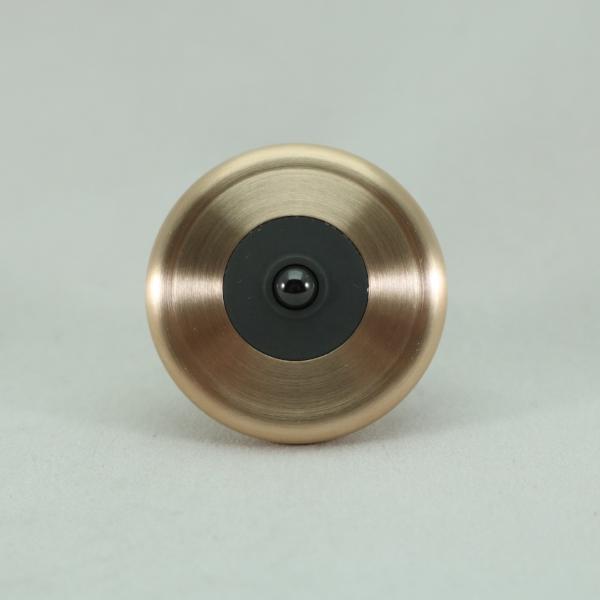 Contrasting colors on the brushed bronze and blacked out stainless steel M3 metal spinning top.