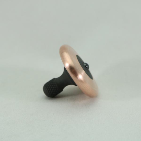 M3 spinning top by Kemner Design shown here in brushed copper and blacked out stainles steel