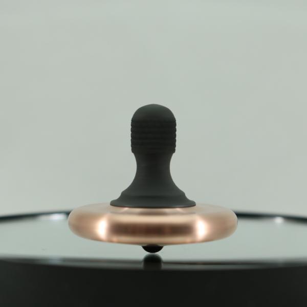The M3 precision spinning top by Kemner Design shown here in brushed copper and blacked out stainless steel with a Si3N4 precision bearing