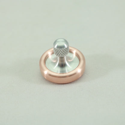 Top view of the Copper and Aluminum Dynamini spinning top by Kemner Design