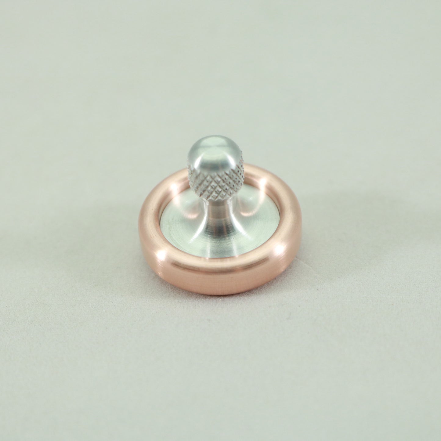 Top view of the Copper and Aluminum Dynamini spinning top by Kemner Design