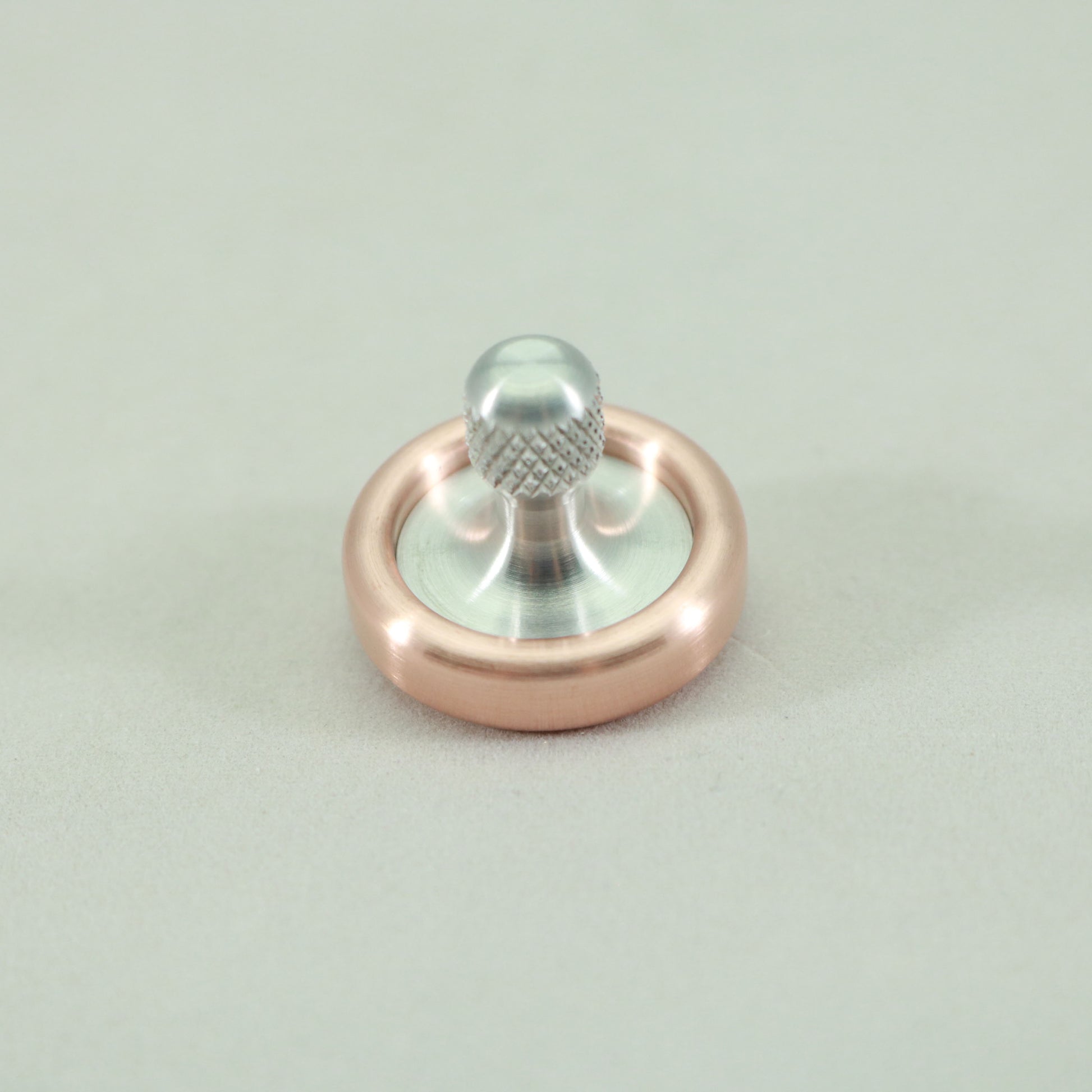 Top view of the Copper and Aluminum Dynamini spinning top by Kemner Design