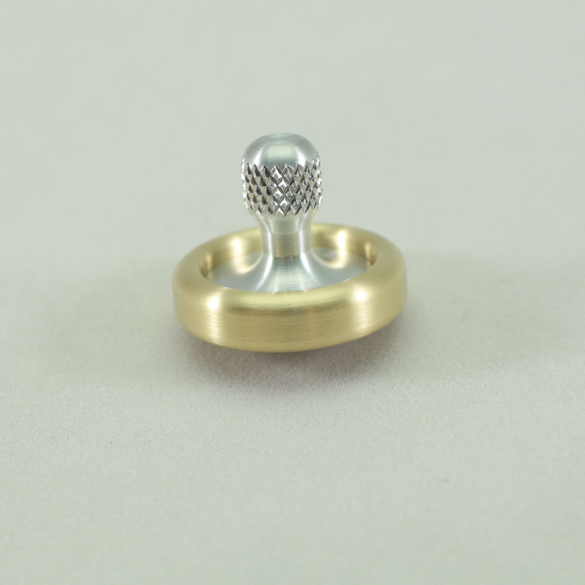 Full view of the Knurled Brass and Aluminum Dynamini Spinning Top