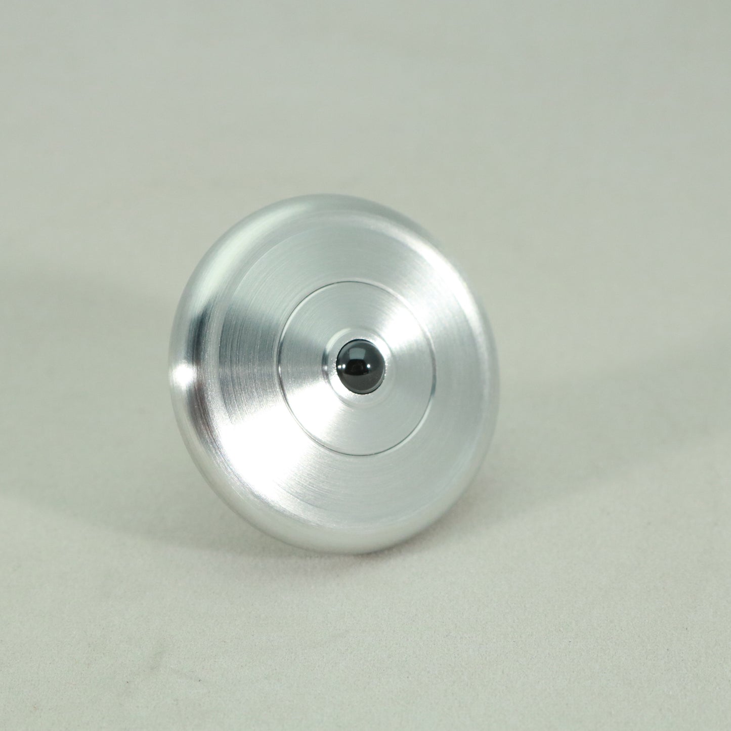 Ceramic bearing on the brushed aluminum version of the M3 precision spinning top by Kemner Design